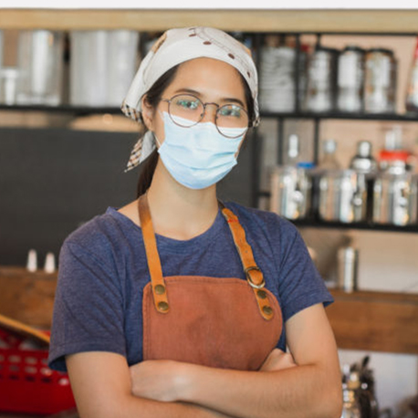 Asian women wearing protective mask standing in cafe during covid-19 preventing.