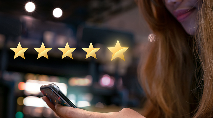Woman internet shopping on smartphone submitting 5 gold star satisfaction feedback - Millennial girl reply to customer experience survey questions by email - Review, success & retention concept