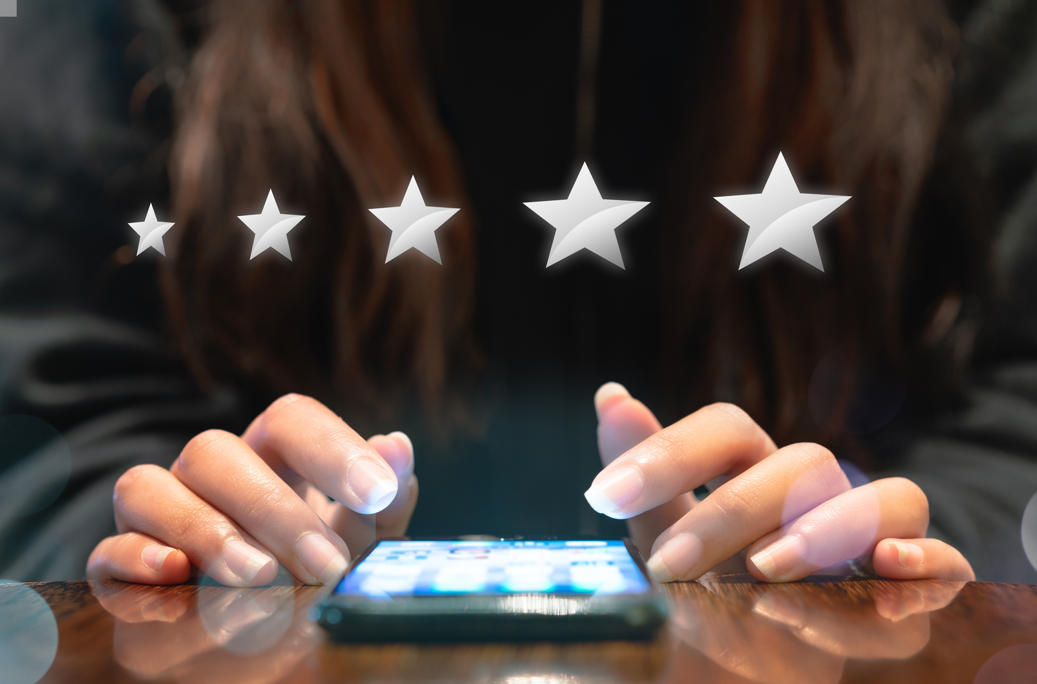 Woman filling out 5 star silver customer service feedback survey by email on smartphone device after hotel guest experience - Company satisfaction rating, retention and quality of service concepts